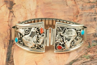 Genuine Sleeping Beauty Turquoise and Coral set in Sterling Silver. Beautiful silver work with Wolf design. Mens Watch Tips includes expandable band. Created by Navajo Artist Cheryl Saunders. 